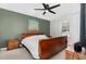 Comfortable bedroom featuring neutral carpet, ceiling fan, and a stylish accent wall at 11 Sherman Rd, Fuquay Varina, NC 27526