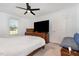 Bright bedroom with a ceiling fan, a cozy bed, and a view of the outdoors from a nearby window at 11 Sherman Rd, Fuquay Varina, NC 27526