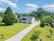 Charming single-story home with a well-manicured lawn, a long driveway, and mature trees at 11 Sherman Rd, Fuquay Varina, NC 27526