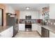 Modern kitchen with stainless steel appliances, white cabinets, and granite countertops at 11 Sherman Rd, Fuquay Varina, NC 27526