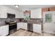 Well-equipped kitchen with gray backsplash, stainless steel appliances, and granite countertops at 11 Sherman Rd, Fuquay Varina, NC 27526