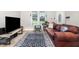 Bright living area featuring sleek wood floors, a large window, and comfortable seating at 11 Sherman Rd, Fuquay Varina, NC 27526