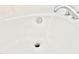Close up of a white porcelain bathtub with a silver drain, faucet, and water running at 1121 Brookhill Way, Cary, NC 27519