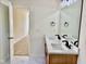 Modern bathroom with double sinks, quartz countertop, and a view into the hallway at 1121 Brookhill Way, Cary, NC 27519