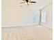 A serene bedroom featuring neutral carpeting and large windows letting in natural light at 1121 Brookhill Way, Cary, NC 27519