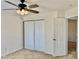 Bedroom has white closet doors, ceiling fan, and view into the hallway at 1121 Brookhill Way, Cary, NC 27519