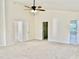 Large primary bedroom with ensuite bathroom, walk in closet and neutral carpet and paint at 1121 Brookhill Way, Cary, NC 27519