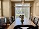 Dining room showcases elegant table set, natural lighting, and neighborhood views at 1121 Brookhill Way, Cary, NC 27519