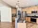 Kitchen with stainless steel refrigerator, granite countertops, and wood cabinets at 1121 Brookhill Way, Cary, NC 27519