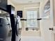 Functional laundry room features modern washer and dryer, window, and stylish decor at 1121 Brookhill Way, Cary, NC 27519