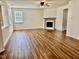 An empty living room with laminate flooring and a fireplace at 1121 Brookhill Way, Cary, NC 27519