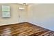 An empty room with beautiful laminate flooring at 1121 Brookhill Way, Cary, NC 27519