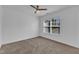 Bright bedroom with carpeted floors, a ceiling fan, and a large window for plenty of natural light at 11309 Shadow Elms Lane Ln, Raleigh, NC 27614