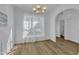 Bright, spacious dining room with wood-look floors, modern lighting, and an open archway at 11309 Shadow Elms Lane Ln, Raleigh, NC 27614