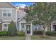 Charming two-story home features a welcoming front porch with stone accents and blooming crape myrtle at 11309 Shadow Elms Lane Ln, Raleigh, NC 27614
