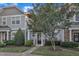 Attractive townhome featuring a manicured lawn, tasteful landscaping, and a welcoming black front door at 11309 Shadow Elms Lane Ln, Raleigh, NC 27614