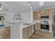 Bright kitchen featuring stainless appliances, sleek countertops, and an open breakfast bar area at 11309 Shadow Elms Lane Ln, Raleigh, NC 27614