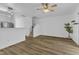 Open-concept living room with wood floors, fan, and view of the staircase at 11309 Shadow Elms Lane Ln, Raleigh, NC 27614