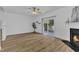 Bright living room with fireplace, wood floors, and sliding glass doors to the outside at 11309 Shadow Elms Lane Ln, Raleigh, NC 27614