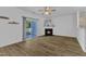 Bright living room with wood-look floors, fireplace, and sliding door access to the outdoor patio at 11309 Shadow Elms Lane Ln, Raleigh, NC 27614