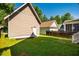 A well-maintained backyard with lush green grass and various outbuildings at 1168 Great Ridge Pkwy, Chapel Hill, NC 27516