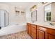 Bathroom with dual sink vanity, soaking tub, and tiled floors at 1168 Great Ridge Pkwy, Chapel Hill, NC 27516