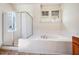 Bright bathroom with a shower, tub, and tile surround at 1168 Great Ridge Pkwy, Chapel Hill, NC 27516