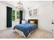 Cozy bedroom with neutral carpet, natural light, and dark green curtains at 1168 Great Ridge Pkwy, Chapel Hill, NC 27516