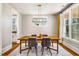 Chic dining room features modern lighting, stylish furniture, and ample natural light through large windows at 1168 Great Ridge Pkwy, Chapel Hill, NC 27516