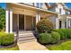Inviting front porch with classic white columns and a well-maintained garden. Ideal spot for relaxing outdoors at 1168 Great Ridge Pkwy, Chapel Hill, NC 27516
