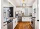 Modern kitchen with stainless steel appliances, white cabinets, and sleek countertops, perfect for cooking enthusiasts at 1168 Great Ridge Pkwy, Chapel Hill, NC 27516