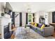 Spacious living room with fireplace, hardwood floors, and large windows at 1168 Great Ridge Pkwy, Chapel Hill, NC 27516