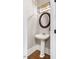 Stylish powder room with pedestal sink and decorative mirror at 1168 Great Ridge Pkwy, Chapel Hill, NC 27516