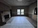 Living room featuring tile floors and a fireplace awaiting restoration at 12670 School House Rd, Middlesex, NC 27557