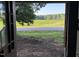 View from the doorway shows a picturesque scene of a field of green next to a road and tree line at 12670 School House Rd, Middlesex, NC 27557