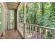 Balcony with painted wood trim and railing overlooking trees, lush landscape and natural light at 1320 Park Glen Drive Dr # 204, Raleigh, NC 27610