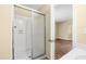 Shower featuring white tile, and glass doors adjacent to other bathroom fixtures at 1320 Park Glen Drive Dr # 204, Raleigh, NC 27610
