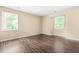 Neutral bedroom featuring hardwood floors and two windows providing natural light at 1320 Park Glen Drive Dr # 204, Raleigh, NC 27610