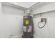 Tight shot of an up-to-code hot water heater in a utility room with white shelving at 1320 Park Glen Drive Dr # 204, Raleigh, NC 27610
