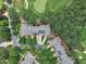 Stunning aerial view of townhomes nestled along a golf course with mature trees and lush landscaping at 1326 Fairview Club Dr, Wake Forest, NC 27587