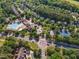 Aerial view of a residential community showcasing the neighborhood pool, tennis courts, and surrounding homes at 1326 Fairview Club Dr, Wake Forest, NC 27587