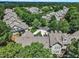Expansive aerial view of homes surrounded by mature trees in a well-maintained community at 1326 Fairview Club Dr, Wake Forest, NC 27587