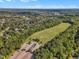 An aerial view of a large community with a sports field, parking area, and houses surrounded by lush greenery at 1326 Fairview Club Dr, Wake Forest, NC 27587