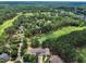 Wide aerial shot featuring a golf course, pond and homes surrounded by mature trees at 1326 Fairview Club Dr, Wake Forest, NC 27587