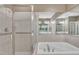 Clean bathroom featuring a tub, shower, and tile surround with ample lighting at 1326 Fairview Club Dr, Wake Forest, NC 27587