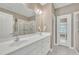 Bright bathroom with double sink vanity, tiled floors, walk-in shower, and ample natural light at 1326 Fairview Club Dr, Wake Forest, NC 27587