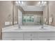 Bright bathroom with double sink vanity, large mirror, tiled floors, and ample lighting at 1326 Fairview Club Dr, Wake Forest, NC 27587