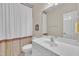 Bathroom with a white vanity, shower with curtains, and framed mirror at 1326 Fairview Club Dr, Wake Forest, NC 27587