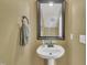 Quaint powder room featuring pedestal sink, neutral wall color, and decorative mirror at 1326 Fairview Club Dr, Wake Forest, NC 27587