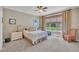 Cozy bedroom features a ceiling fan, neutral walls, and bright window with lush view at 1326 Fairview Club Dr, Wake Forest, NC 27587